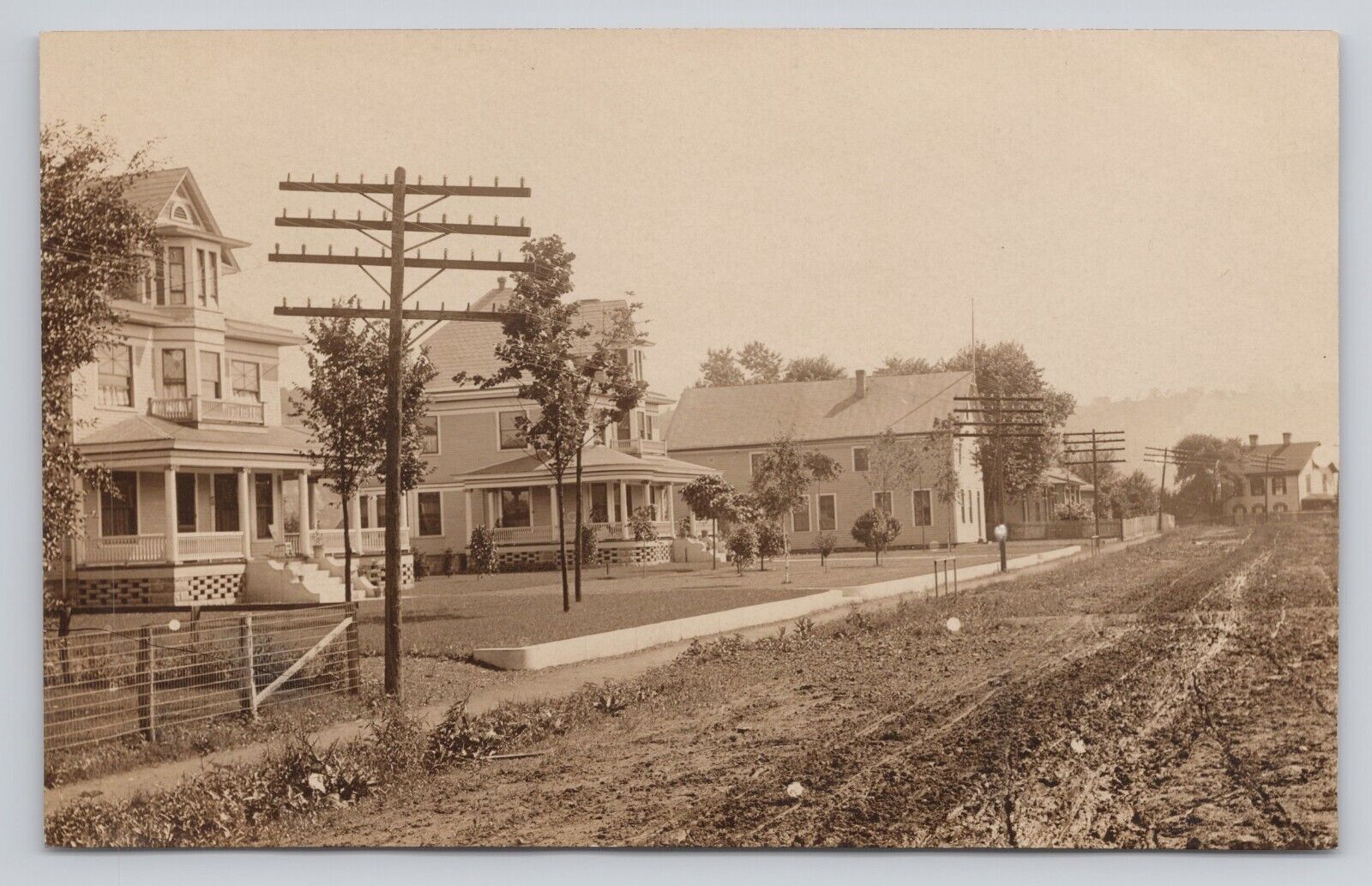 Postcard RPPC Street Scene Telephone Poles Residences homes Dirt Road  c1918