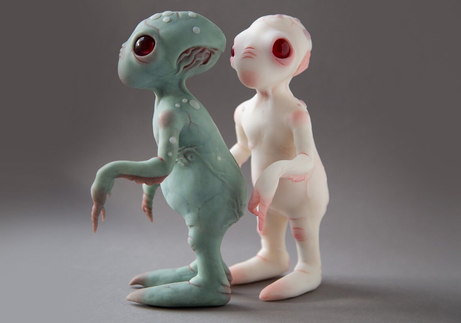 Grey alien baby doll sculpture, cute small extraterrestrial lifeform.