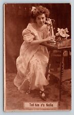 c1910 Lady on Phone at Table Tell Him it's Nellie ANTIQUE Postcard 1030 picture